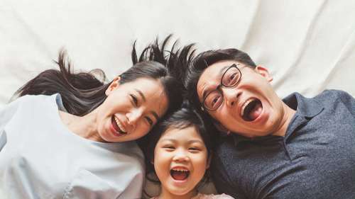 a mom and dad having fun with their daughter in mirrabooka
