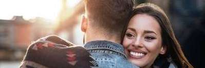 woman smiling while hugging man in mirrabooka 